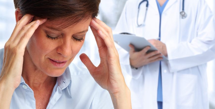 Woman having a migraine headache.