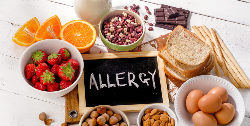 Food allergy. Allergic food on  wooden background.