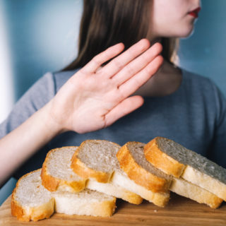 gluten-intolerance-concept-young-girl-refuses-to-eat-white-bread-shallow-depth-of-field
